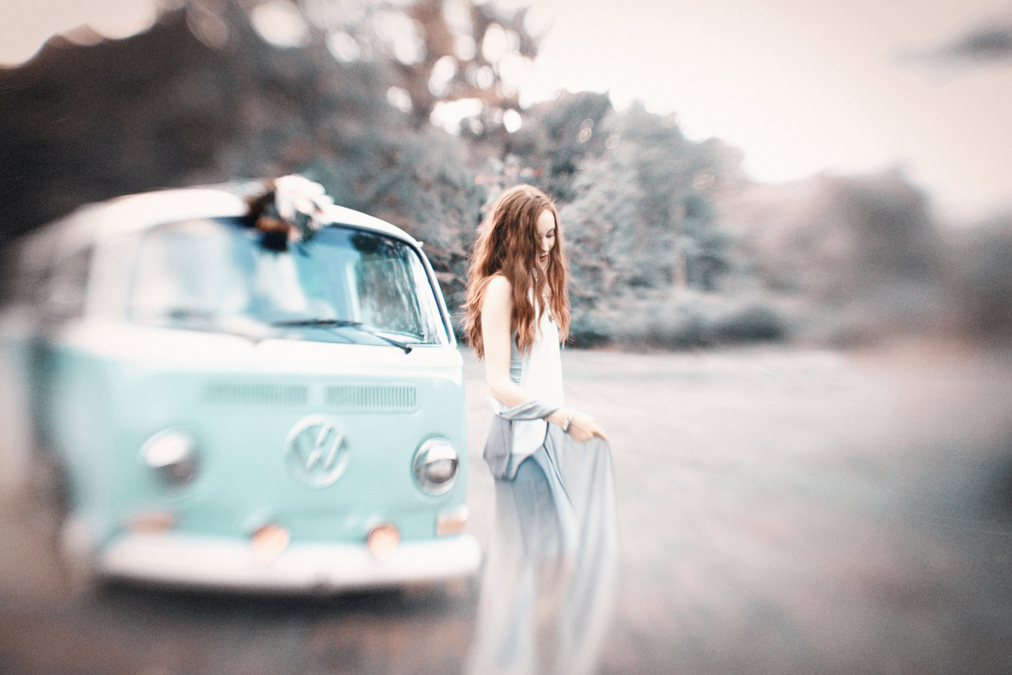 wavy haired woman in silky dress in front of teal green vw bus selective focus Scottie Magro gallery