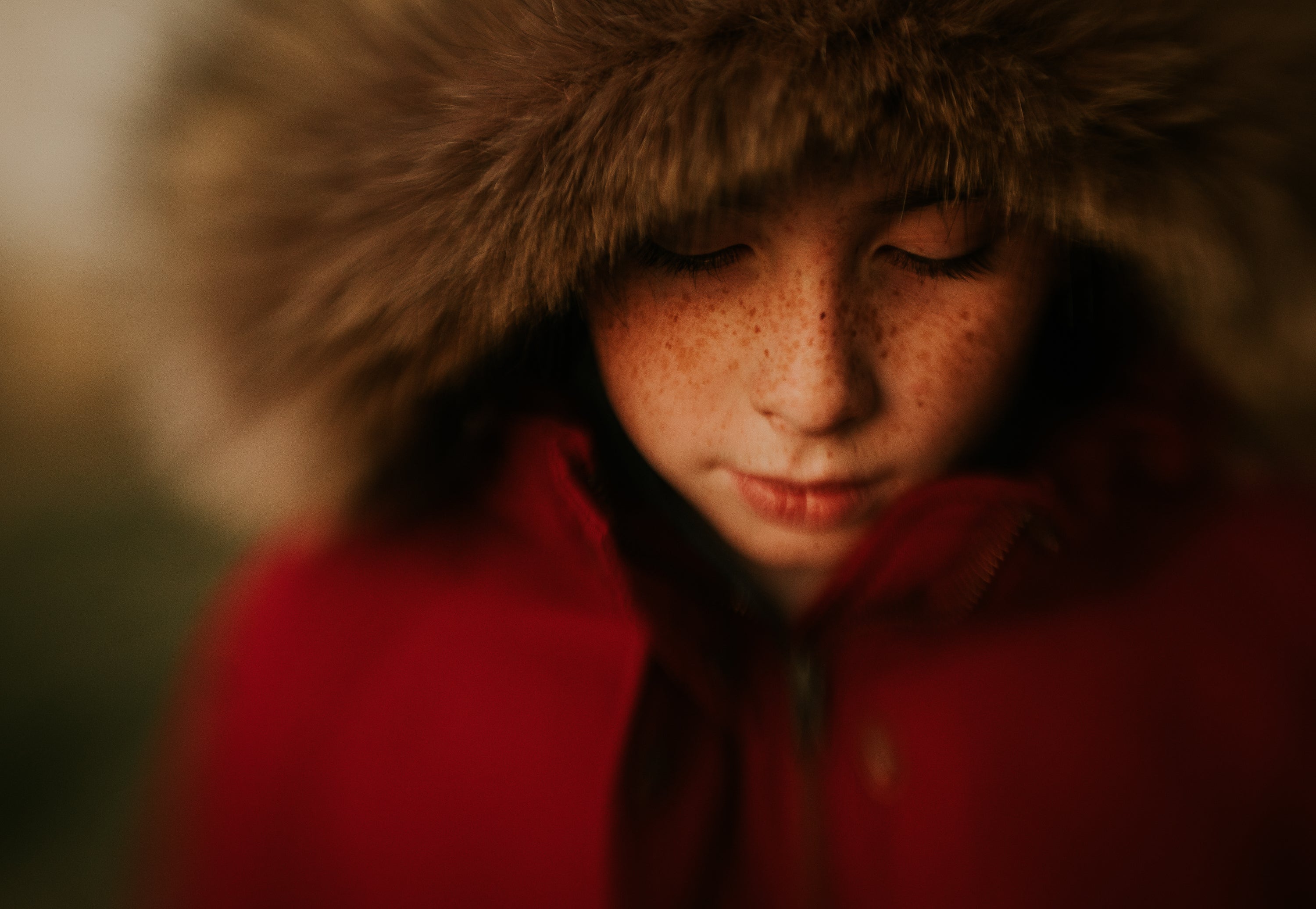 boy with freckles and red lips in red jacket with fur journey story amy cyphers