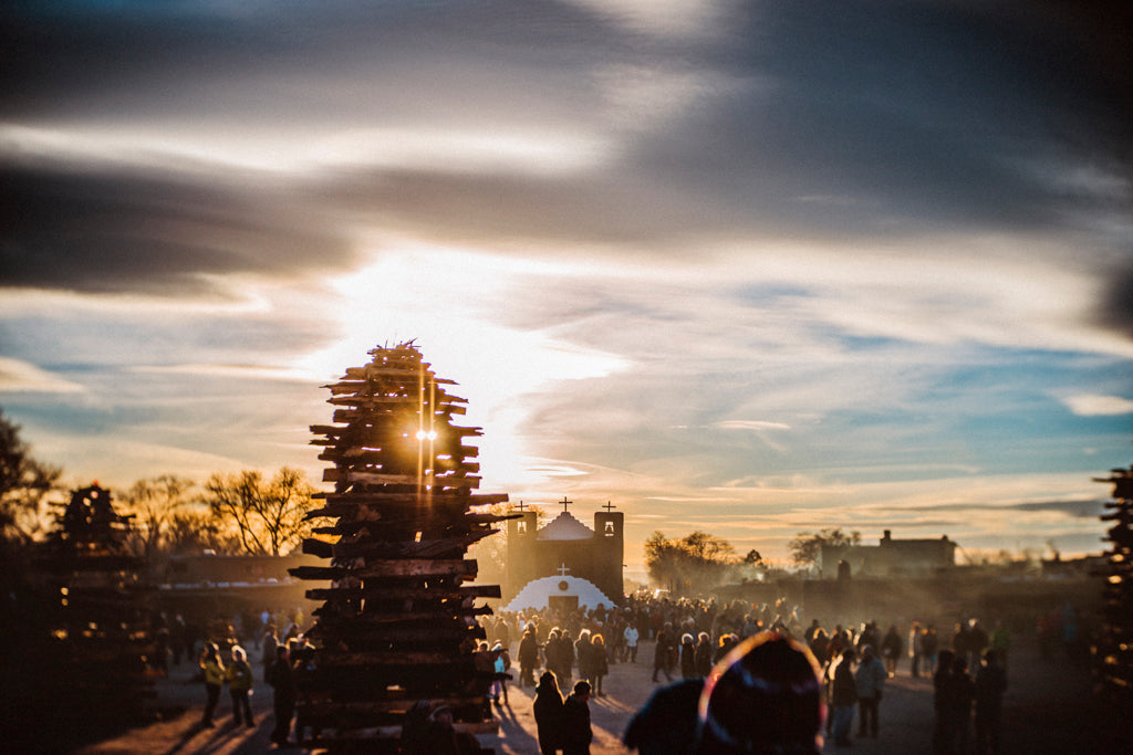 tall tower of wooden logs with sun peaking through in busy middle eastern city Lensbaby Featured Photos street photography