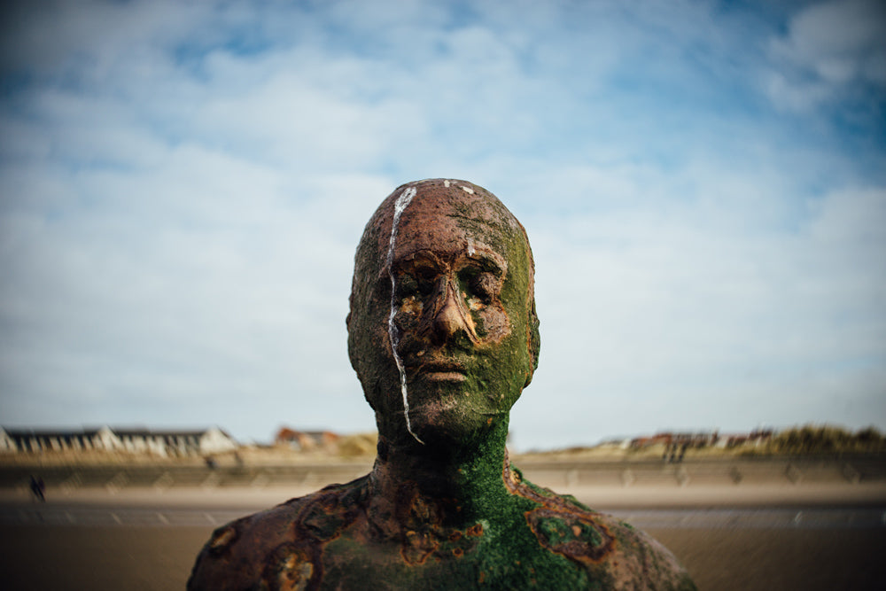 iron statue by the beach black and white Anthony Gormley's Another Place UK beach janet broughton Lensbaby Burnside 35