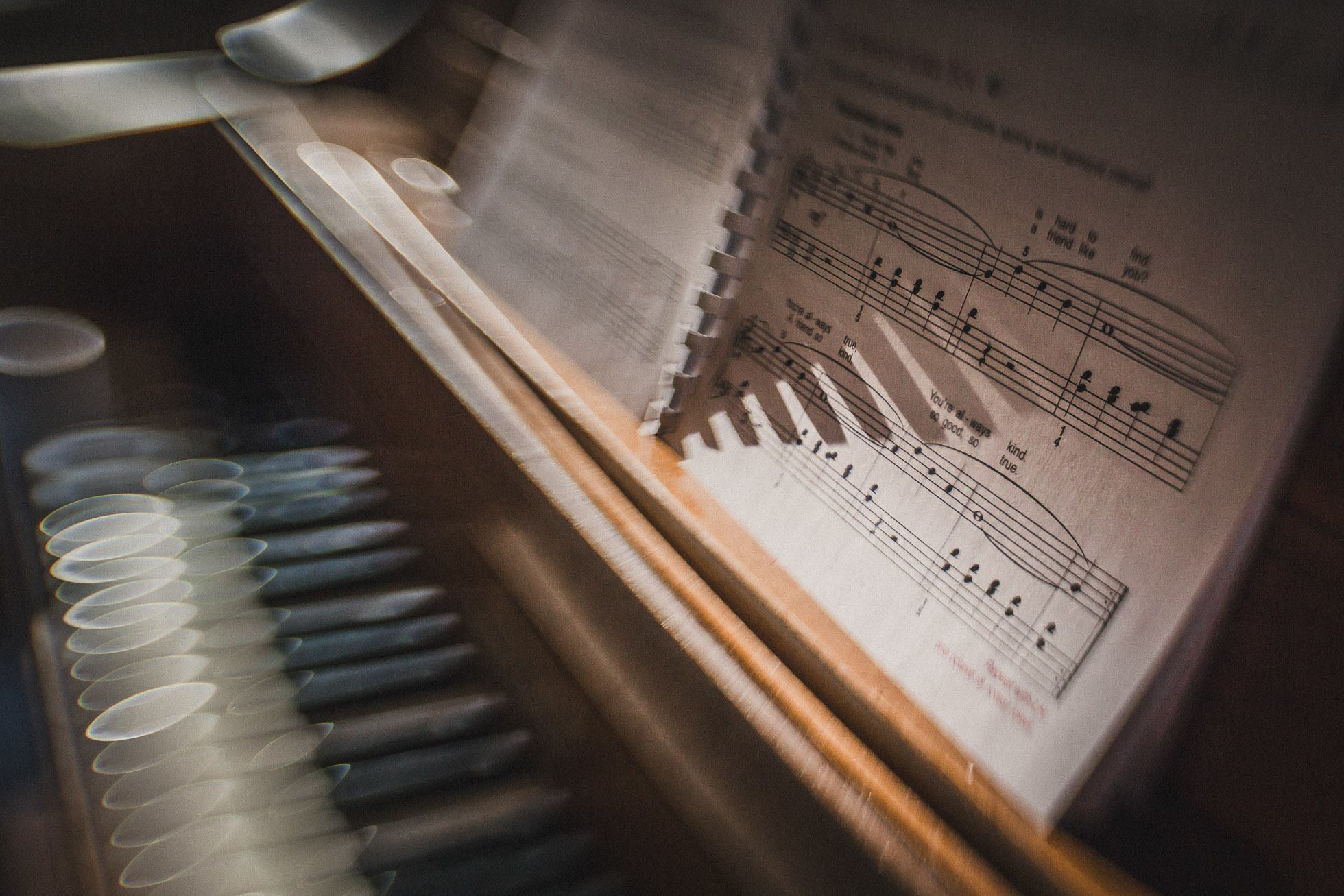 sheet music on a piano long shadows from spiral notebook keys keyboard lensbaby featured photos