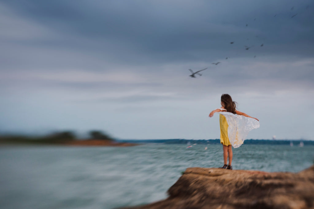 Girl standing on cliff